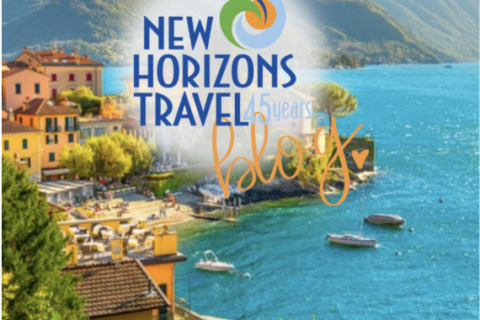 A scenic coastal town with colorful buildings, turquoise water, and green hills in the background, overlaid with the New Horizons Travel 45 Years Blog logo.